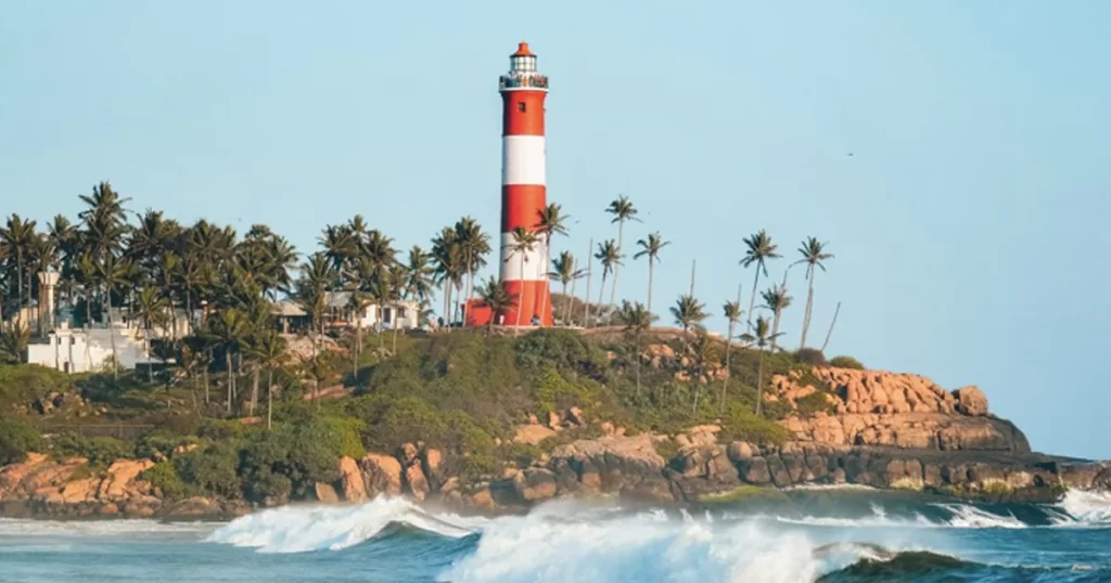 Kovalam Beach, Kerala with river and lighthouse on hills cover with trees